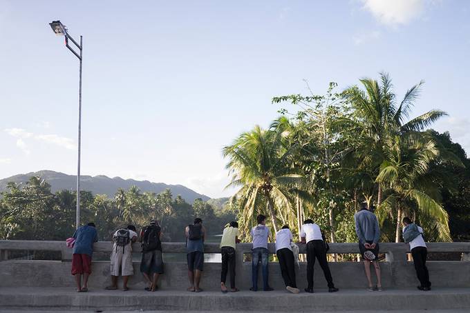 Men looking down at the river