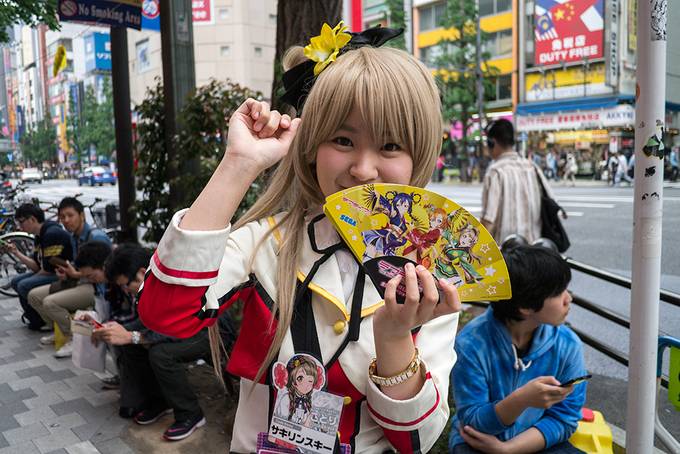 A girl dressed up handing out fliers