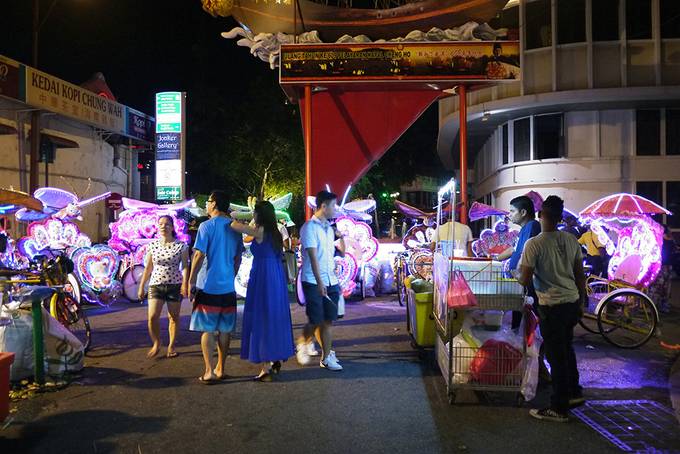 Trishaws lit up at night